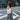 Woman crossing the street wearing a canvas tote on her shoulder