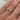 person-wearing-gold-band-with-two-main-diamonds-and-one-melee-accent-diamond-set-into-engraved-band
