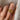 A vintage 22k yellow gold band with olive branch imagery worn on a person's finger.