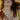 smiling-woman-tossing-hair-wearing-necklackes-and-stacks-of-rings
