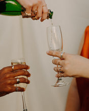 Load image into Gallery viewer, person-wearing-rings-pouring-glasses-of-champagne