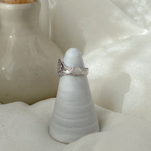 Load image into Gallery viewer, Cloud detail on sterling silver ring in front of white neutral backdrop.