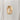 Tall, melty gold ring on a light gray background