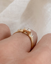 Load image into Gallery viewer, Side view of diamond in a raised setting on a gold ring.