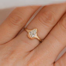 Load image into Gallery viewer, A pear-shaped white diamond ring set in a 14k gold band, displayed on a person&#39;s finger.