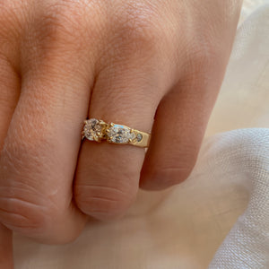 person-wearing-wide-gold-band-with-two-main-diamonds-and-one-accent-diamond