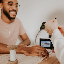 Load image into Gallery viewer, A person, who is smiling, is getting a permanent bracelet