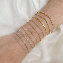 Load image into Gallery viewer, Arm displaying various types of sterling silver and 14k gold chains