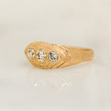 Load image into Gallery viewer, A gold ring with three white diamonds set in a hand-engraved pattern on the band.