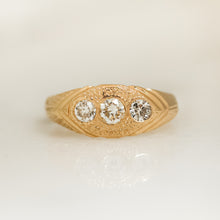 Load image into Gallery viewer, A gold ring with three white diamonds set in a hand-engraved pattern on the band.