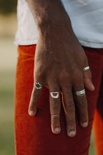 Load image into Gallery viewer, man-wearing-sapphire-half-halos-and-arched-wedding-band
