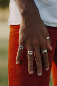 man-wearing-sapphire-half-halos-and-arched-wedding-band
