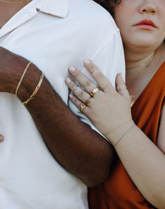 woman-wearing-stack-of-gold-and-silver-rings
