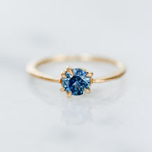 Load image into Gallery viewer, A solitaire ring featuring a cornflower blue sapphire solitaire, with a gold band and six claw prongs.