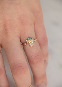 pear diamond engagement ring with diamond and sapphire crown cluster 