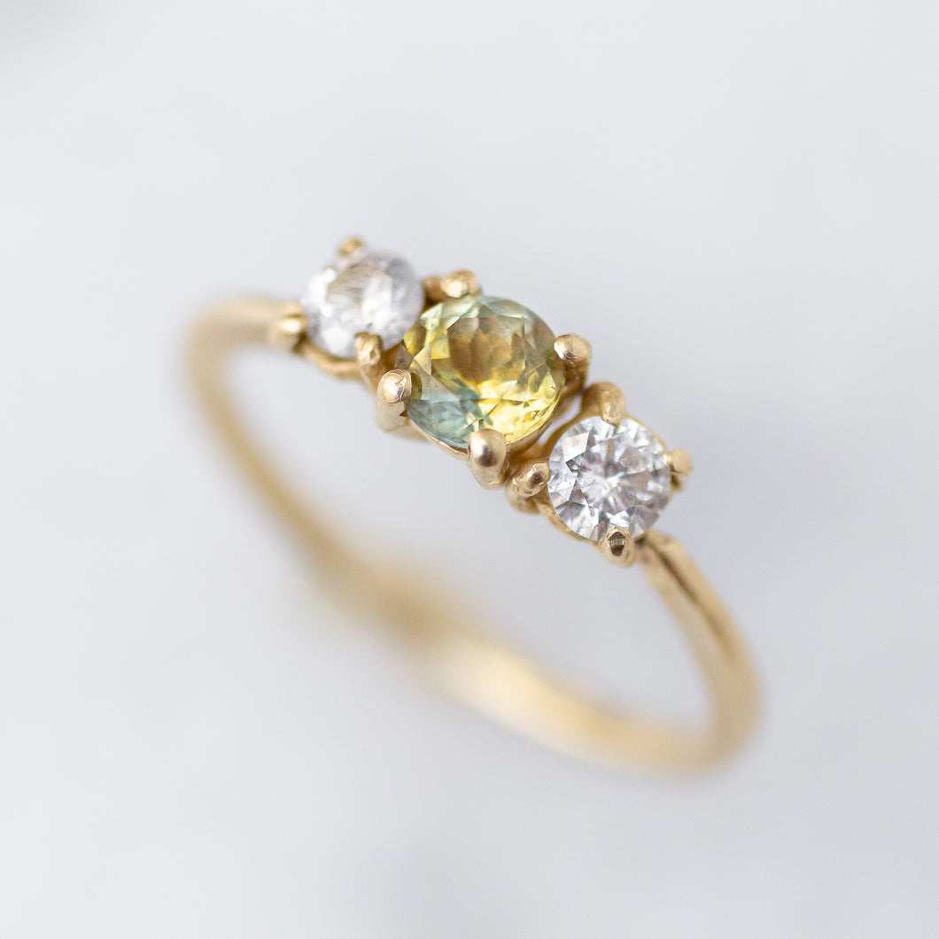 Three Stone Ring with a Blue/Yellow Parti Sapphire and two diamond accents