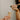woman-pouring-overflowing-champage-into-a-flute-held-by-hand-wearing-lots-of-rings