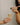 woman-pouring-overflowing-champage-into-a-flute-held-by-hand-wearing-lots-of-rings