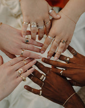 Load image into Gallery viewer, circle-of-hands-wearing-lots-of-silver-and-gold-rings-and-bands