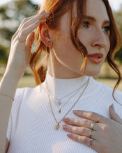 Load image into Gallery viewer, red-head-wearing-layered-gold-and-silver-necklaces-and-earrings