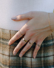Load image into Gallery viewer, woman-wearing-black-diamond-arched-half-halo-ring-and-gold-bands