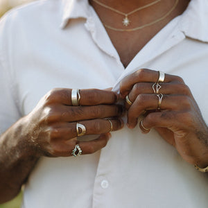 man-wearing-silver-and-gold-stacking-rings-and-half-halos