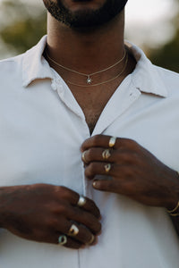 man-wearing-gold-chain-and-diamond-sunburst-necklace