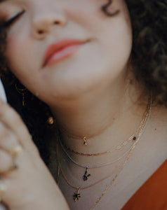 woman-wearing-stack-of-silver-and-gold-necklaces-and-chains