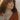 curly-haired-woman-wearing-orange-dress-and-rings