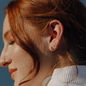 Woman-wearing-chain-earring-threaded-through-multiple-piercings