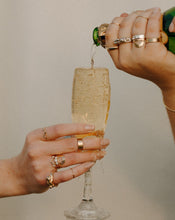 Load image into Gallery viewer, hands-with-rings-pouring-overlowing-champagne-into-flute