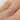 person wearing a rose cut diamond & opal 14k gold engagement ring