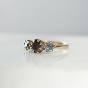 Black brilliant cut diamond with blue sapphires set in 14k gold
