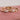 three-diamond-engagement-rings-on-pink-background