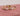 three-diamond-engagement-rings-on-pink-background