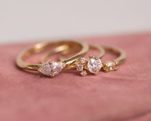 Load image into Gallery viewer, three-diamond-engagement-rings-on-pink-background