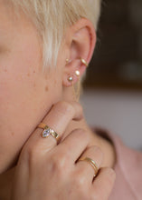 Load image into Gallery viewer, Person wearing a wide band with a north to south set marquise diamond in a bezel setting