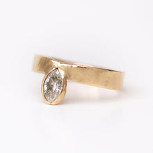 Load image into Gallery viewer, A marquise diamond ring with a recycled 14k gold band, set on a white background.