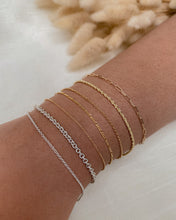 Load image into Gallery viewer, woman-wearing-stack-of-sterling-silver-and-14k-gold-bracelets