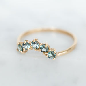 five-blue-sapphires-in-curved-half-halo-design