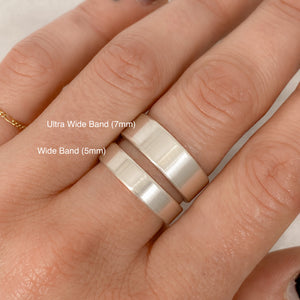 person wearing two sterling silver bands, one is 5mm tall and the other is 7mm tall