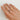 Pearson with triangle tattoo on middle finger wearing a extra tall, half dome yellow gold wedding band
