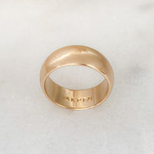 Load image into Gallery viewer, Half dome, yellow gold wedding band lying on its side with inside engraving of &quot;14KPFA&quot; visible