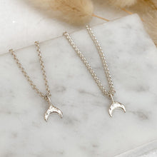 Load image into Gallery viewer, sterling-silver-crescent-moon-necklaces-lying-side-by-side-on-a-marble-surface