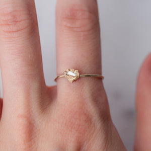 Melted gold nugget engagement ring with raw diamond.